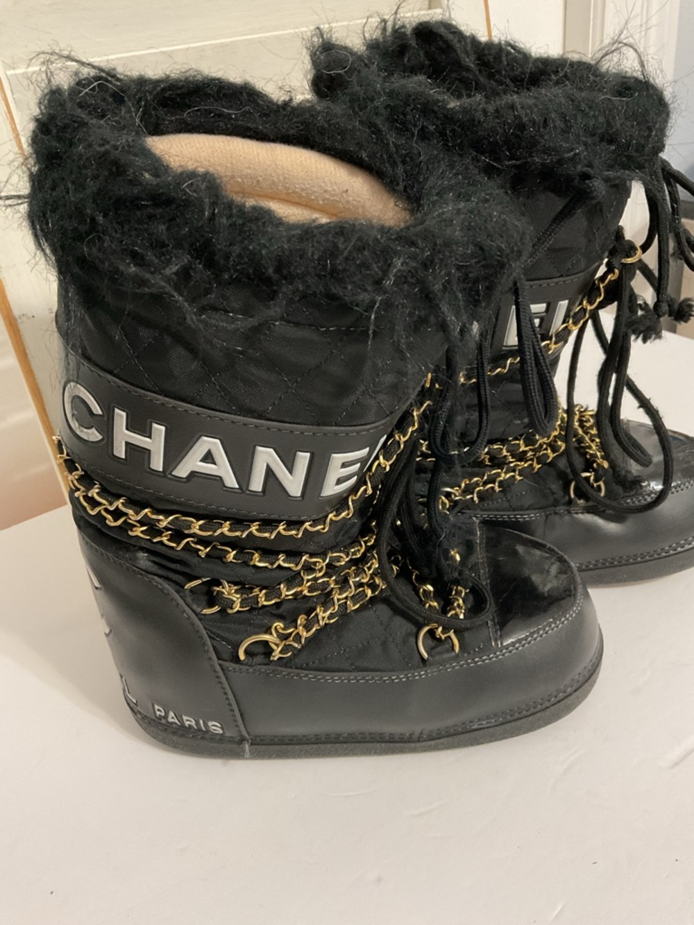 CHANEL Black and Gold Quilted Winter Lace-Up Boots